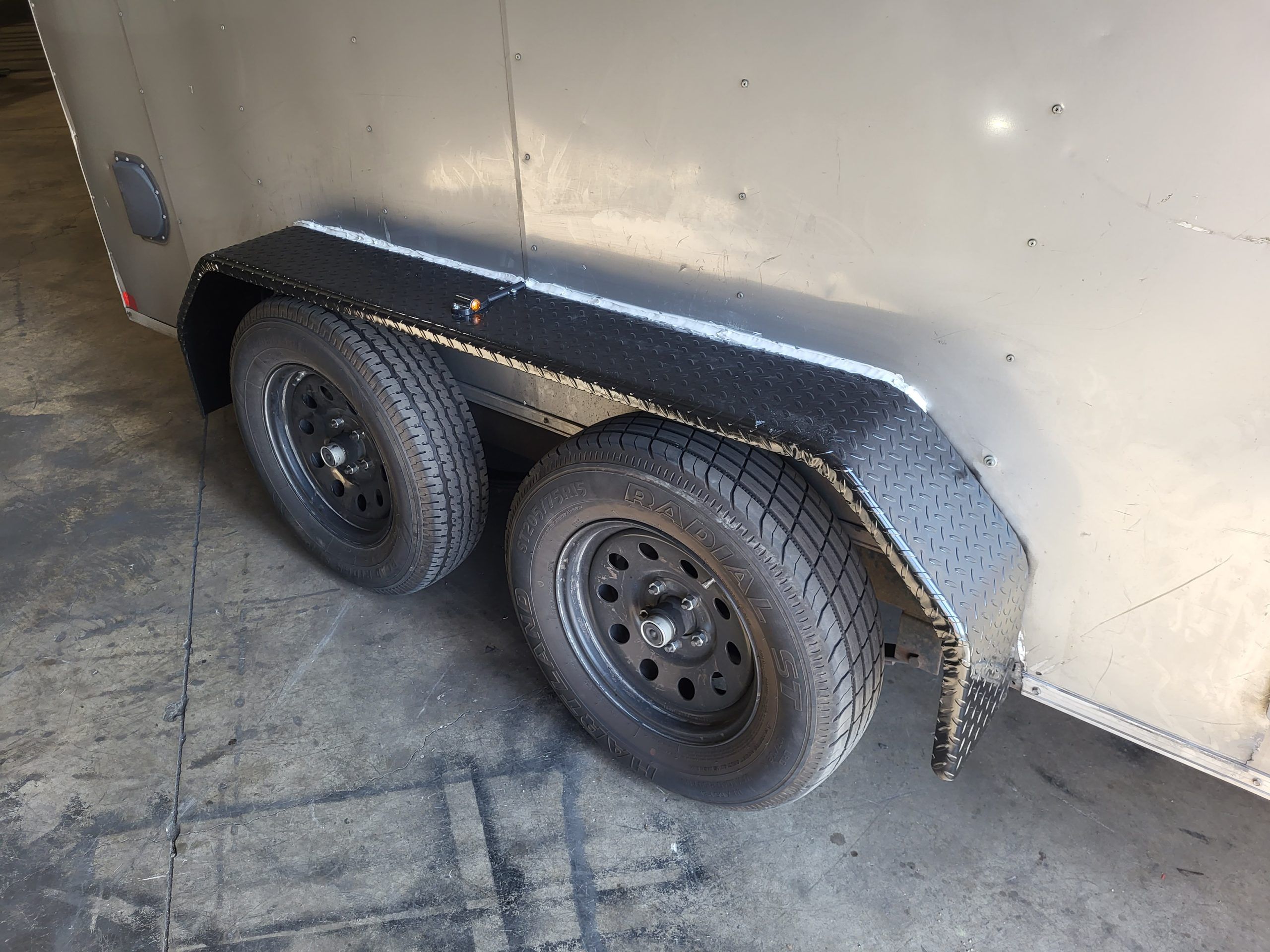 Repaired trailer fender and wheel after welding work